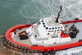 Tug Boat tow line attached to ship to maneuver the mooring/docking process. Royalty Free Stock Photo