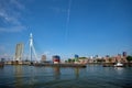 Tug boat towing barge with containers under open bascule part of Erasmusbrug bridge