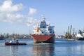 Tug boat towing container ship in harbor Royalty Free Stock Photo