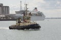 Tug and cruise ship in port Royalty Free Stock Photo