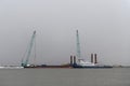 Tug moored to bardge. Construction Marine offshore works. Dam building, crane, barge, dredger