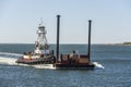 Tug Realist maneuvering barge against wind and current