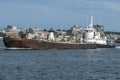 Tug Thuban pushing barge against New Bedford waterfront background