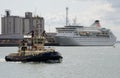 Tug underway with a cruise ship Southampton Docks Royalty Free Stock Photo