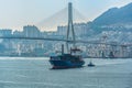 Tugboat assist a container ship on the way out of the harbor Royalty Free Stock Photo