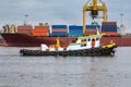 tugboat assisting bulk cargo ship to harbor freight Royalty Free Stock Photo