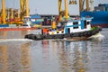 Tugboat assisting bulk cargo ship to harbor freight Royalty Free Stock Photo