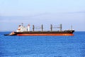 Tugboat assisting bulk cargo ship Royalty Free Stock Photo