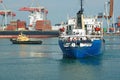 Tugboat assisting bulk cargo ship Royalty Free Stock Photo