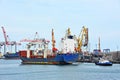 Tugboat assisting bulk cargo ship Royalty Free Stock Photo