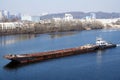 A tugboat with a barge is sailing along the Dnieper