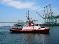 Tugboat in container harbor