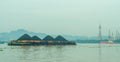 Tugboat drag barge full of coal crossing Mahakam River, Samarinda, in the morning. Royalty Free Stock Photo