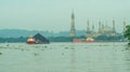 Tugboat drag barge full of coal crossing Mahakam River, Samarinda, in the morning. Royalty Free Stock Photo