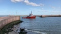 tugboat entering the harbor of Scheveningen on the Dutch North Sea coast