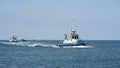 Tugboat escorting a ship on the way to the port of Swinoujscie in Poland