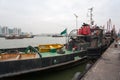 Tugboat and fishing vessels are at berth in the port of Macao.