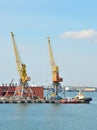 Tugboat and freight train under port crane Royalty Free Stock Photo