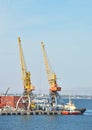 Tugboat and freight train under port crane Royalty Free Stock Photo