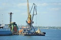 Tugboat and freight train under port crane Royalty Free Stock Photo