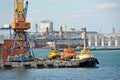 Tugboat and freight train under port crane Royalty Free Stock Photo