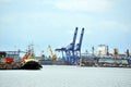 Tugboat and freight train under port crane Royalty Free Stock Photo