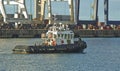 Tugboat leaving a harbor Royalty Free Stock Photo