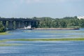 Tugboat moves empty barge along the picturesque river.