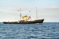 Tugboat and passenger ship sailing on Wadden Sea, Netherlands