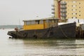 A tugboat in the process of being converted to a pleasure craft tied up at the quayside in Hythe harbour on Southampton Water on t