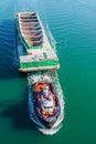 Tugboat pulling barge with cargo by water, aerial view. Tugboat pulling empty barge in Vancouver Harbour BC Canada