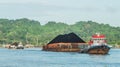 Tugboat pull heavy loaded barge of coal Royalty Free Stock Photo