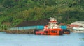 Tugboat pulling barge full of black coal in Mahakam river, Borneo, indonesia Royalty Free Stock Photo