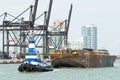 Tugboat pulling a barge in the Port of Miami