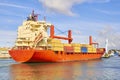 Tugboat pulls a large cargo ship to port. Transportation and logistics work Royalty Free Stock Photo