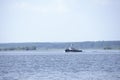 Tugboat pushes sand debris along the river