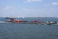 Tugboat pushing barge in New York Harbor