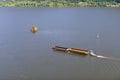 Tugboat pushing barge on the picturesque river