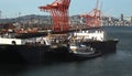 Tugboat pushing a ship into a dock