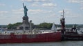 Tugboat Pushing Ship In Harbor