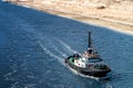 Tugboat runs in the new extension section of the Suez Canal