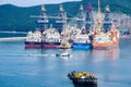 Tugboat sails pass driil ships in the Bay of Daewoo Shipbuilding and Marine Engineering DSME in Okpo city, South Korea.