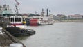 Tugboat and Steamboat Natchez docked on the Mississippi River, New Orleans, Louisiana