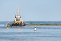 Tugboat, tow ship inner harbor sea city. Vessel for tow another ships. Buoys on the water, copy space Royalty Free Stock Photo