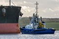 Tugboat towing Cargo Ship