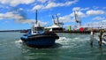 Tugboat works at Captain Cook Wharf in Ports of Auckland, New Zealand