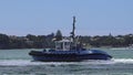 Tugboat works at Captain Cook Wharf in Ports of Auckland, New Zealand