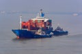 Tugboats assist container ship. Royalty Free Stock Photo