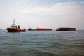 Tugs and barges in Singapore anchorage.