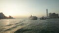 Tugs Escort a larger ship through Victoria Harbour in Hong Kong